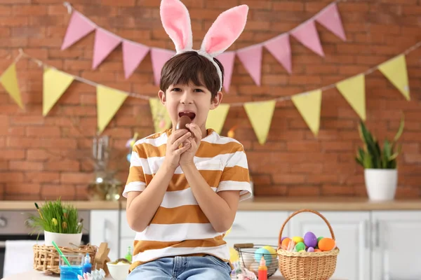 Cute Little Boy Bunny Ears Eating Tasty Chocolate Easter Egg — Stock Photo, Image