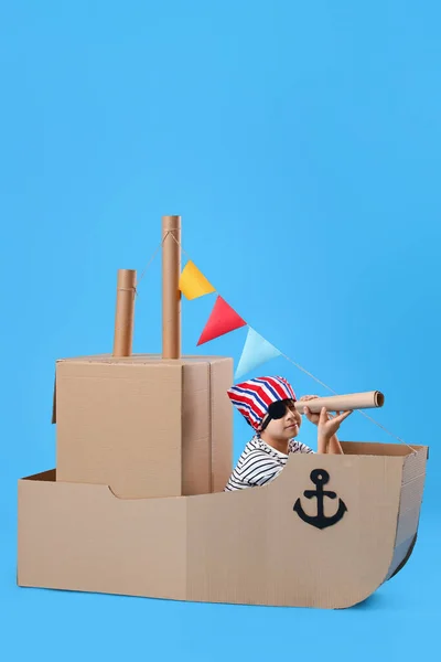Cute Little Boy Playing Cardboard Ship Blue Background — Stock Photo, Image