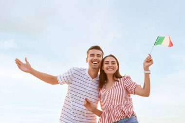 Açık havada İtalyan bayrağı taşıyan genç çift