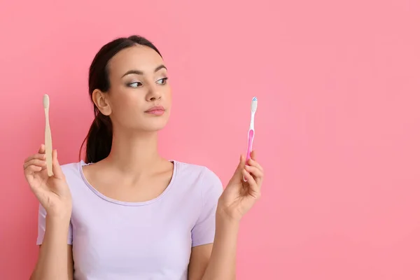 Thoughtful Young Woman Different Toothbrushes Pink Background — Stock Photo, Image