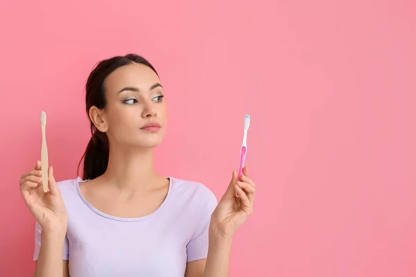 Thoughtful Young Woman Different Toothbrushes Pink Background — Stock Photo, Image