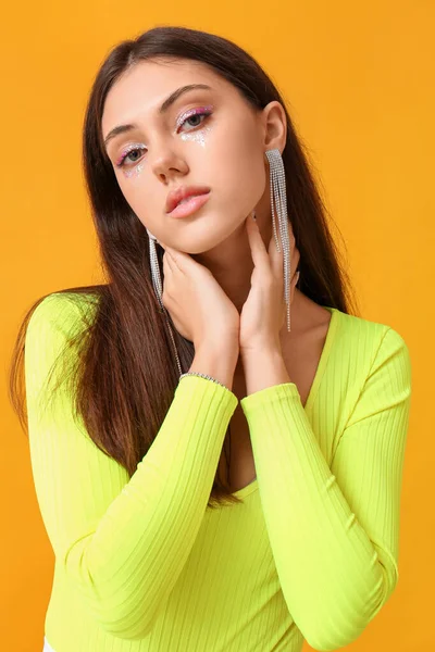 Woman Creative Makeup Stylish Jewelry Touching Neck Yellow Background — Stock Photo, Image