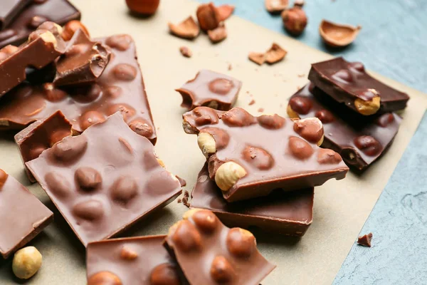 Pieces Tasty Chocolate Nuts Parchment — Stock Photo, Image
