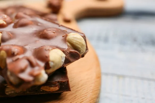 Pieces Tasty Chocolate Hazelnuts Board Closeup — Stock Photo, Image