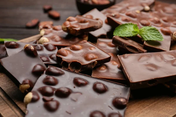 Pieces Tasty Chocolate Hazelnuts Board Closeup — Stock Photo, Image