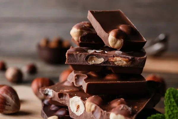 Pieces Tasty Chocolate Hazelnuts Closeup — Stock Photo, Image