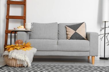 Kanepesi ve sonbahar dekoru olan güzel bir oturma odası.