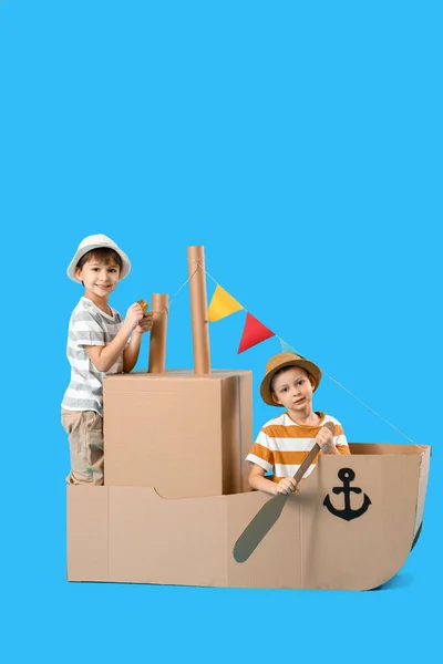 Funny Little Boys Playing Cardboard Ship Blue Background — Stock Photo, Image