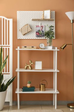 Tahtası, raf ünitesi ve katlama ekranı olan şık bir oda.