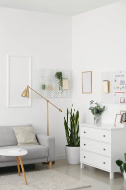 Oturma odasının içinde kanepe ve asma tahtalar var.