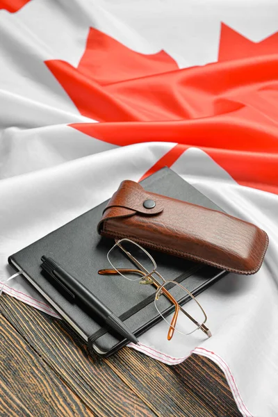 Notebook Pen Eyeglasses Canadian Flag Dark Wooden Background — Stock Photo, Image