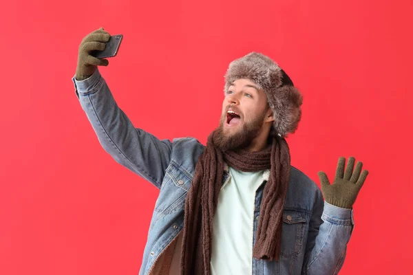 Young Bearded Man Warm Gloves Taking Selfie Red Background — Stock Photo, Image
