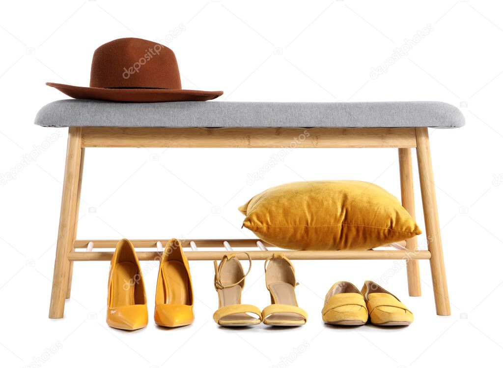 Soft bench with hat, pillow and female shoes on white background