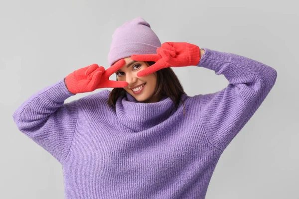 Young Woman Red Gloves Hat Showing Victory Gesture Light Background — Stock Photo, Image