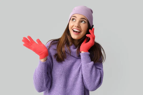 Young Woman Red Gloves Hat Talking Mobile Phone Light Background — Stock Photo, Image