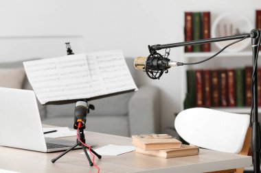 Laptop, kitap ve mikrofonları olan modern işyeri