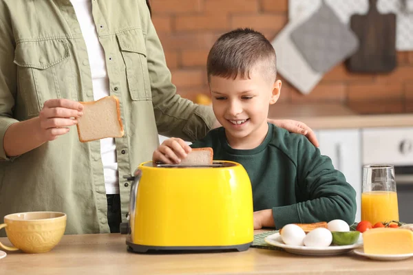 Little Boy His Mother Putting Bread Slices Toaster Kitchen — Stock Photo, Image