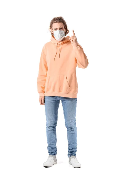 Jongeman Medisch Masker Met Opgeheven Wijsvinger Witte Achtergrond — Stockfoto