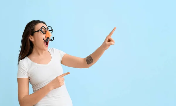 Young Woman Funny Disguise Pointing Something Blue Background April Fools — Stock Photo, Image