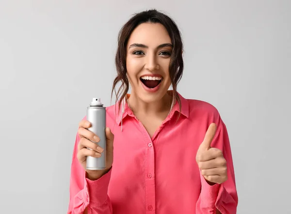 Pretty Young Woman Hair Spray Showing Thumb Grey Background — Stock Photo, Image