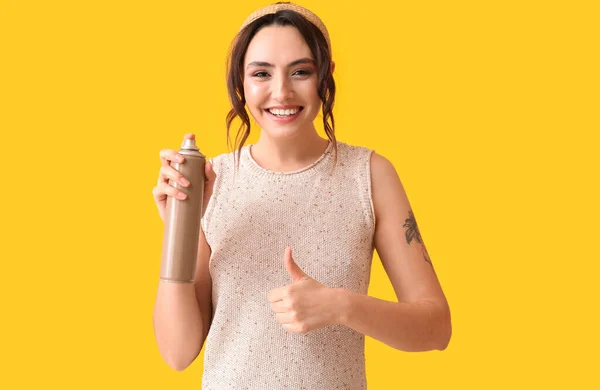 Pretty Young Woman Hair Spray Showing Thumb Yellow Background — Stock Photo, Image