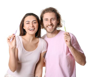 Beyaz arka planda diş fırçası olan mutlu genç bir çift.