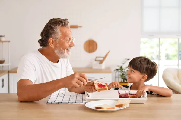 Little Boy His Grandfather Making Sandwiches Jam Table Kitchen — Stock Photo, Image