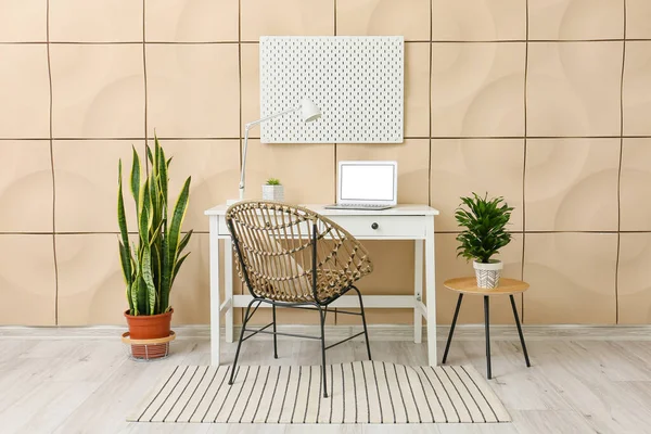 Modern workspace and office supplies with peg board on wall