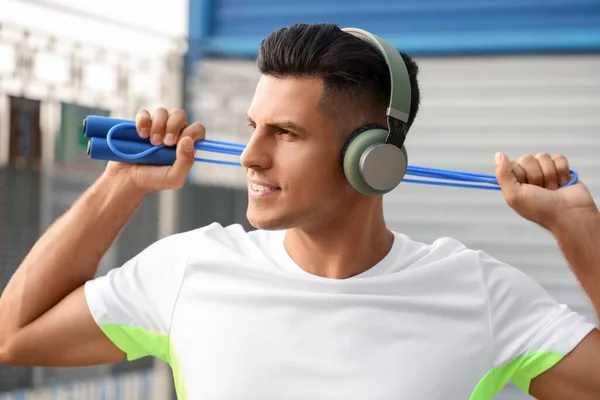 Sporty Young Man Skipping Rope Listening Music Outdoors — Stock Photo, Image