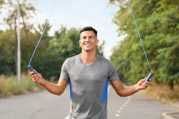 Sporty Young Man Jumping Rope Outdoors — Stock Photo, Image