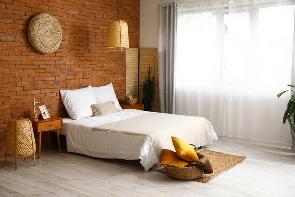 ウィッカーランプとレンガの壁とスタイリッシュなベッドルームのインテリア — ストック写真