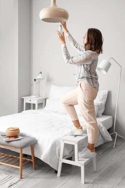 Woman Changing Light Bulb Hanging Lamp Home — Stock Photo, Image