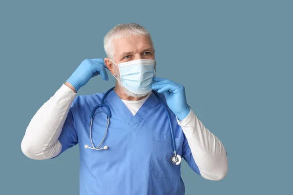 Mature Male Doctor Wearing Medical Mask Blue Background — Stock Photo, Image