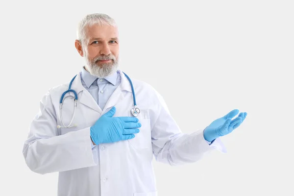 Mature Male Doctor Stethoscope Showing Something White Background — Stock Photo, Image