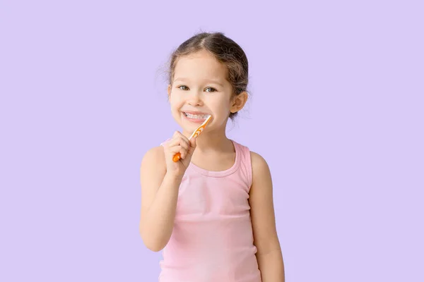 Adorable Little Girl Brushing Teeth Lilac Background — Stock Photo, Image