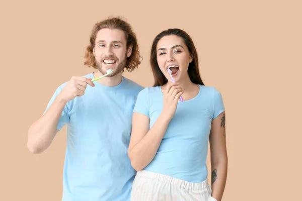 Young Couple Brushing Teeth Beige Background — Stock Photo, Image