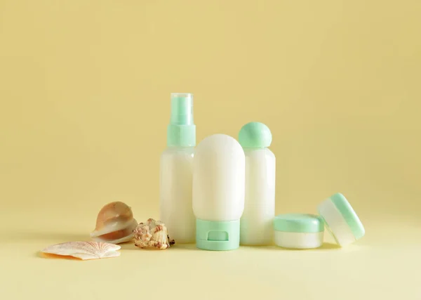 Travel Bottles Jars Cosmetic Products Sea Shells Beige Background — Stock Photo, Image