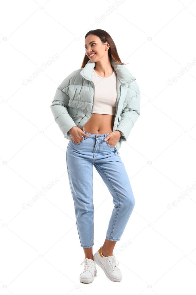 Pretty young woman in warm clothes on white background