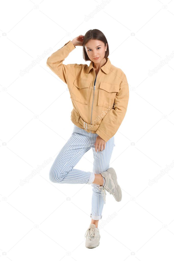 Pretty young woman in stylish clothes on white background