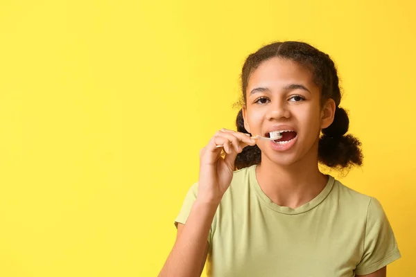 African American Teenage Girl Brushing Teeth Yellow Background — Stock Photo, Image