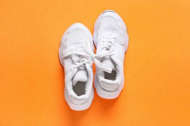 Turuncu arka planda bağcıklı ayakkabılar. 1 Nisan şakası.