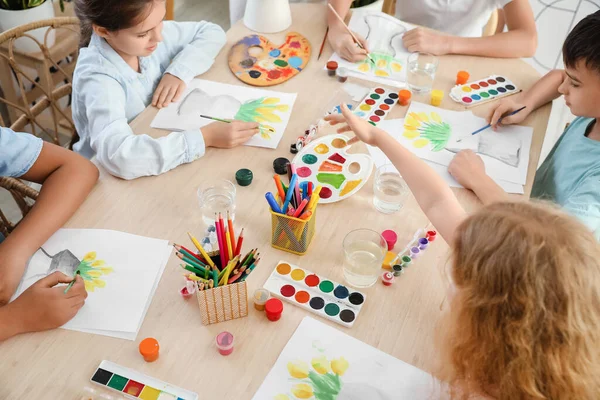 Cute children painting during master-class in art