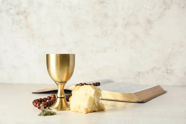 stock image Cup of wine with bread, rosary and Holy Bible on light background