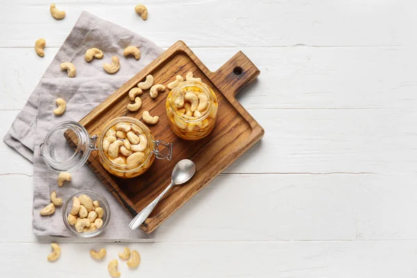 Jars Tasty Cashew Nuts Honey White Wooden Background — Stock Photo, Image