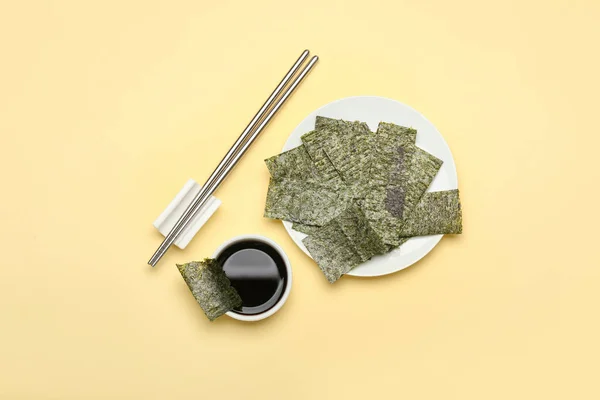 Plate Tasty Seaweed Sheets Bowl Soy Sauce Chopsticks Yellow Background — Stock Photo, Image