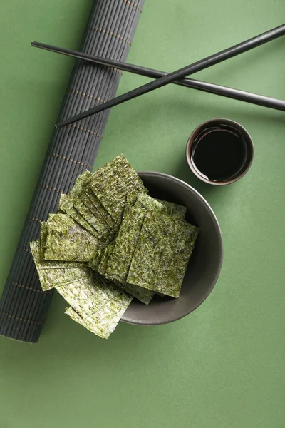 Bowl Tasty Seaweed Sheets Soy Sauce Chopsticks Green Background — Stock Photo, Image