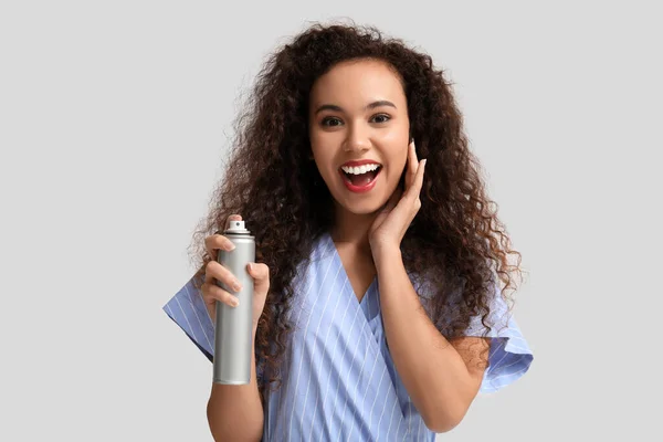 Happy Young African American Woman Hair Spray Light Background — Stock Photo, Image