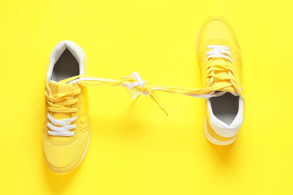 Shoes Tied Laces Yellow Background April Fool Day Prank — Stock Photo, Image