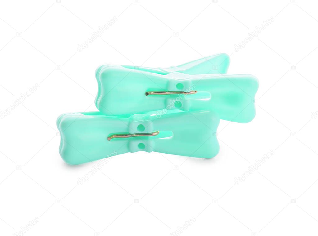 Plastic clothes pins on white background