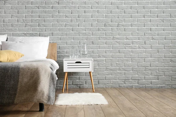 Jug Water Glasses Nightstand Grey Brick Wall Bedroom — Stock Photo, Image